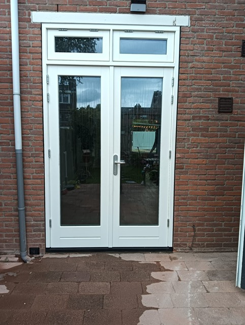 Detail van het hoogwaardige hang- en sluitwerk op de houten deuren.